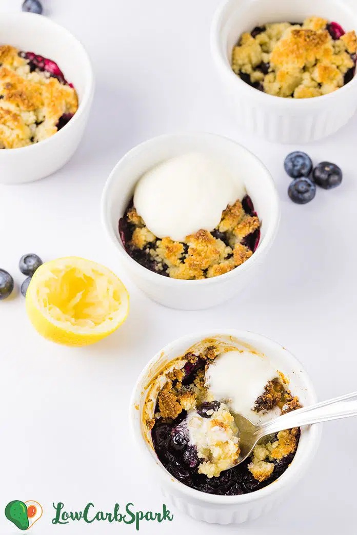 This Keto Blueberry Cobbler is a quick and easy keto dessert that's very versatile and low in carbs.  The blueberry filling is thick and bubbly with a golden almond flour topping perfect for a scoop of sugar-free ice cream or whipped cream. Recipe via www.lowcarbspark.com