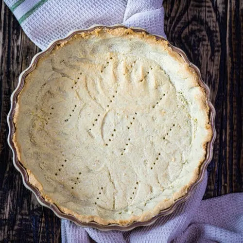 Gluten-Free Savory Keto Pie Crust 5 Freshly baked savory keto pie crust in a pie pan, golden brown and flaky, ready to be filled with a delicious low-carb quiche or tart.