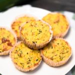 Learn how to make gluten-free Zucchini Savory Muffins for the best on-the-go keto breakfast option. They're moist, keto-friendly, and perfect for meal prepping. These low carb zucchini muffins are buttery with a garlicky taste, moist inside, and the best crispy golden top.