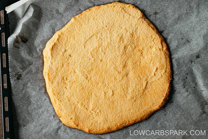 almond flour keto pizza crust baked in the oven with crispy edges