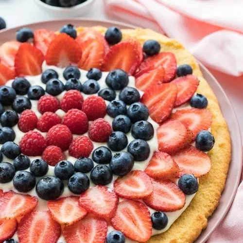 Keto Fruit Pizza with Cream Cheese Frosting - 4g net carbs! 12 best keto fruit pizza decorated with berries and cream cheese frosting