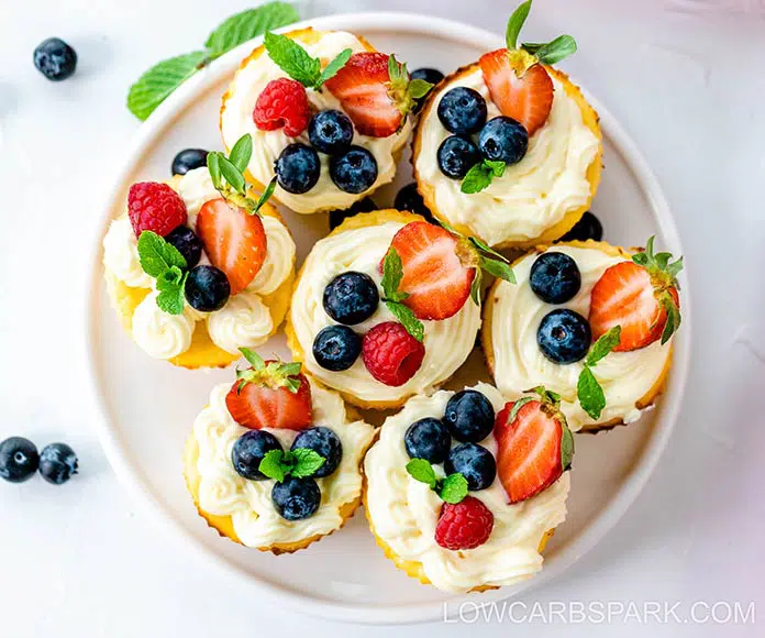 Keto Mini Cheesecakes 5 keto mini cheesecake bites served with berries on a white plate