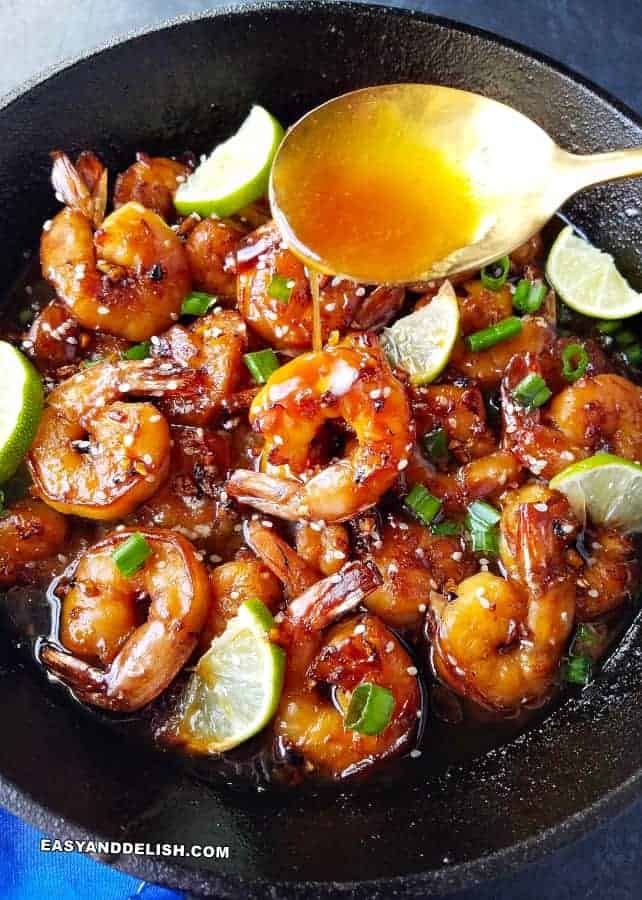Honey Garlic Butter Shrimp Skillet Recipe pouring sauce