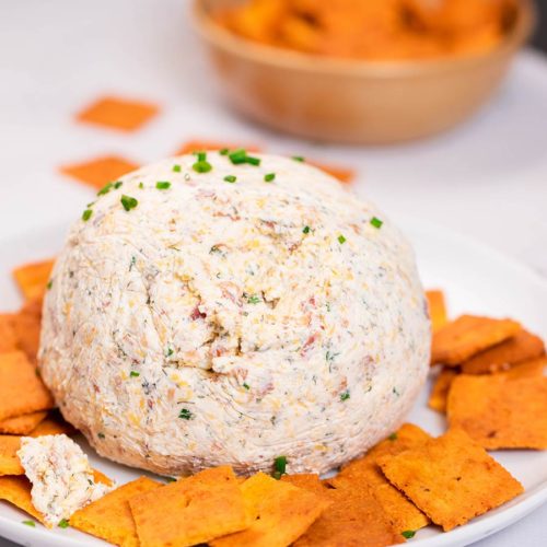 homemade cheese ball recipe served with crackers and topped with chives