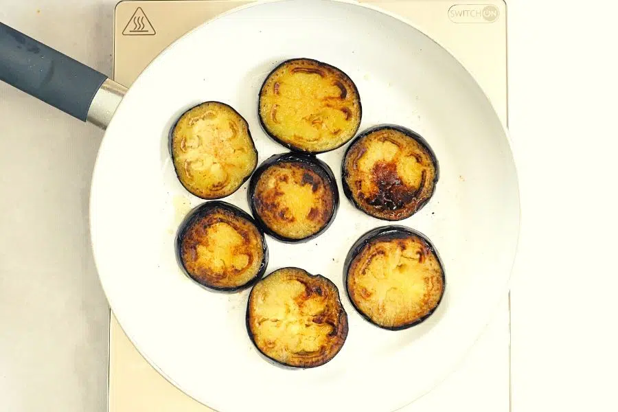 sauteed eggplants in a white pan