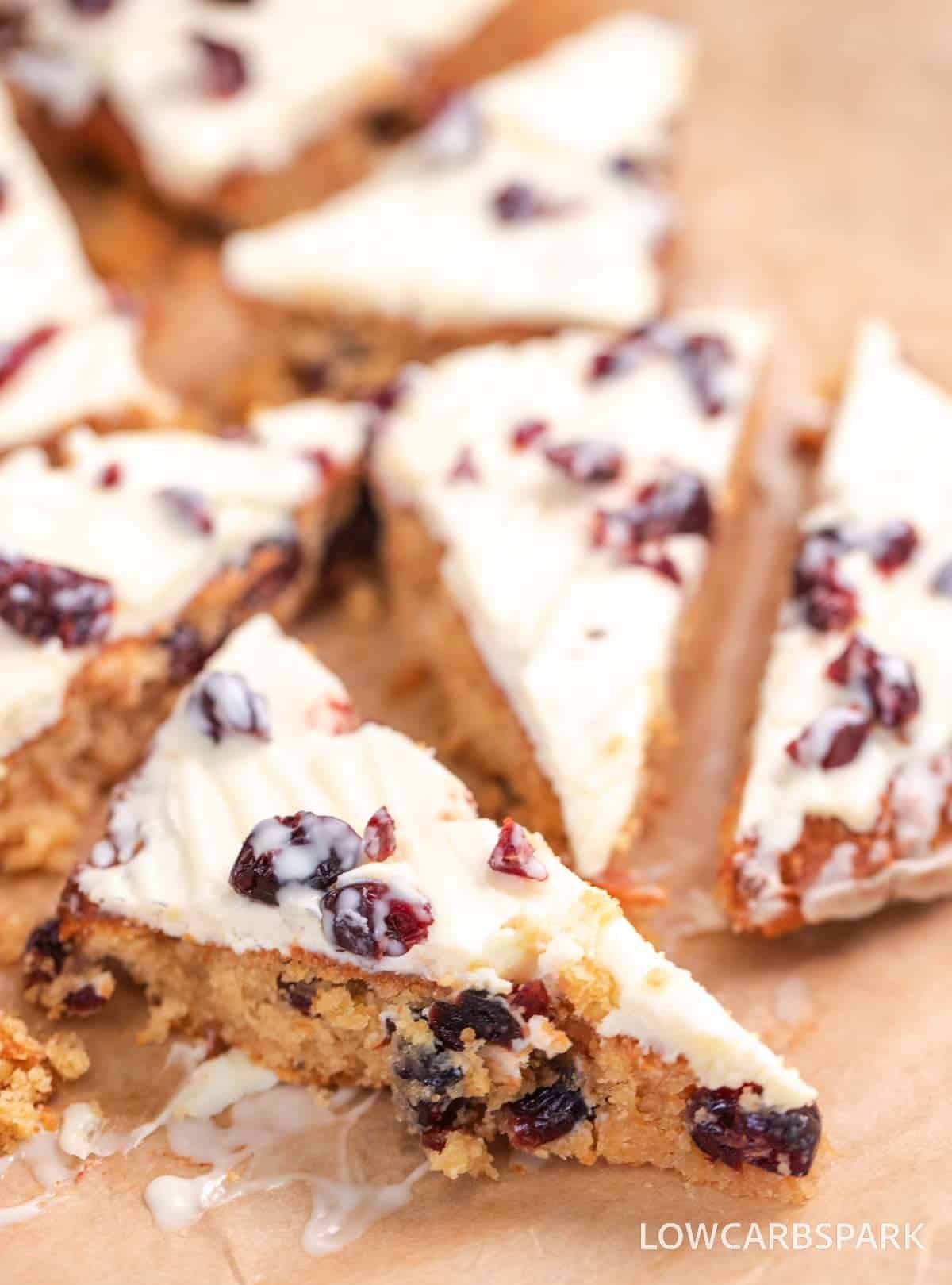 Final keto cranberry bliss bars drizzled with white chocolate and topped with cranberries