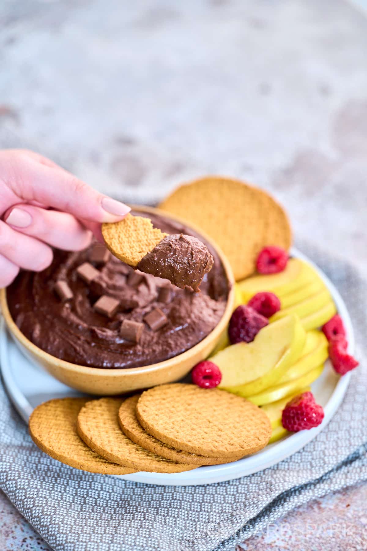 Chocolate Hummus Recipe on a serving plate with cookies and fruit