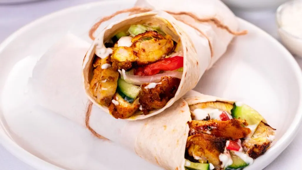 Easy Chicken Shawarma 1 Chicken shawarma wraps filled with juicy spiced chicken, cucumbers, tomatoes, onions, lettuce, and creamy yogurt sauce.