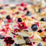 "Frozen Greek yogurt bark broken into pieces, revealing berries and granola toppings.