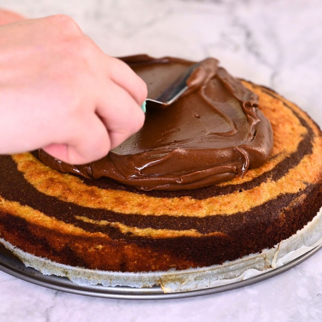 frosting the zebra cake with sugar free chocolate frosting