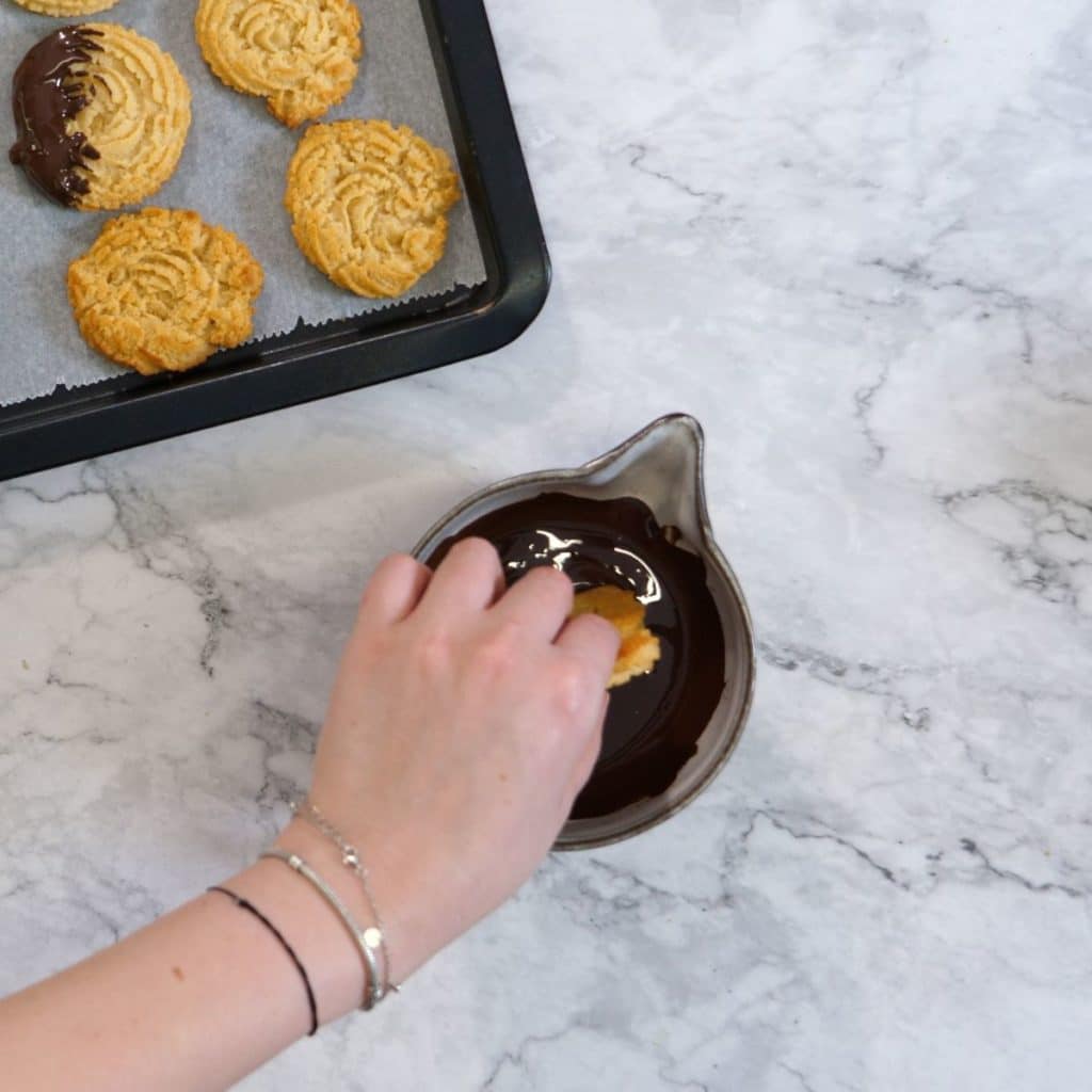 dip each butter cookie in melted chocolate