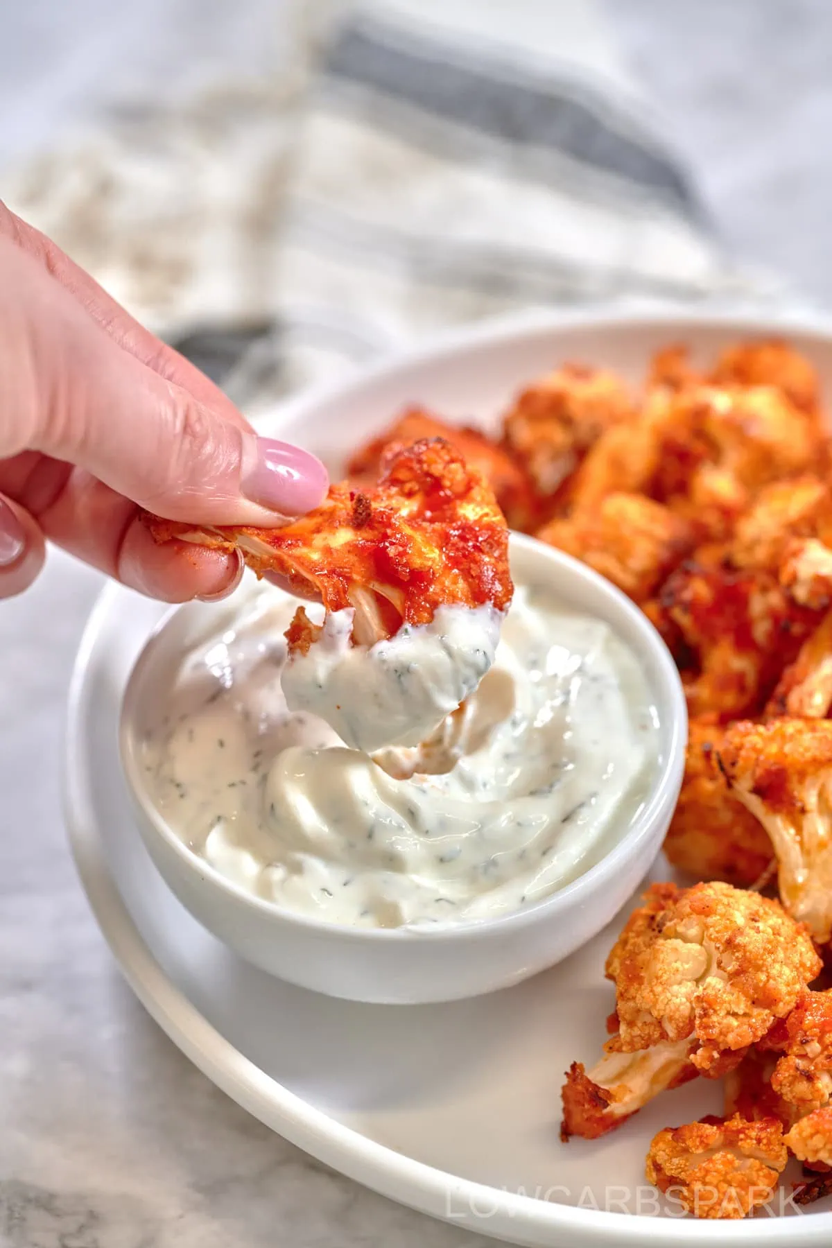 Air Fryer Buffalo Cauliflower 2 Crispy Air Fryer Buffalo Cauliflower bites dipped in creamy ranch sauce