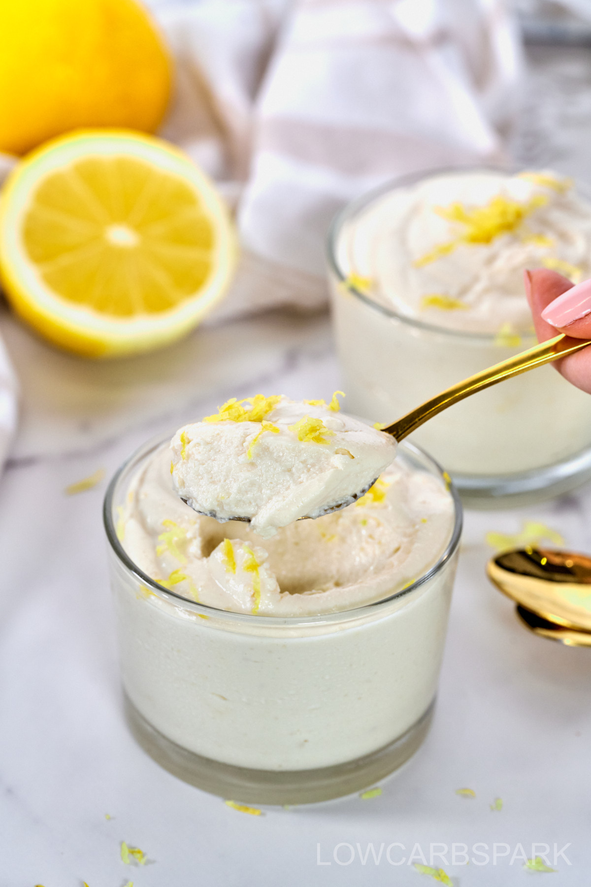 creamy lemon cottage cheese recipe in a glass with a gold spoon to show texture