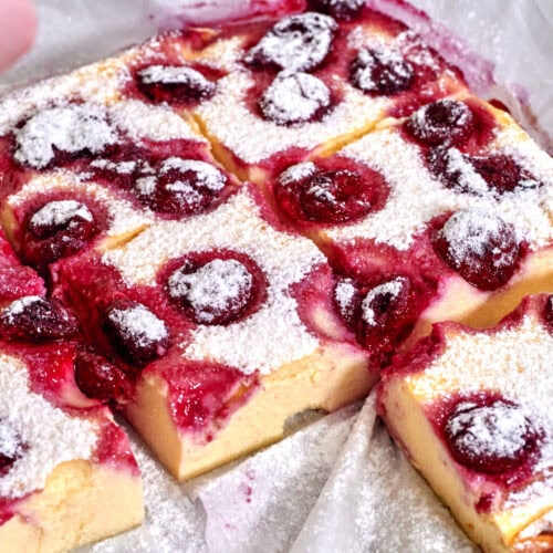 Berry Cottage Cheese Clafoutis 11 view of freshly baked berry cottage cheese clafoutis in a baking dish, golden-brown with juicy berries on top.