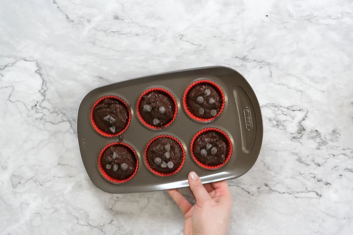 Cottage Cheese Protein Muffins 10 Keto-friendly and high-protein chocolate muffins ready for the oven in a non-stick pan.