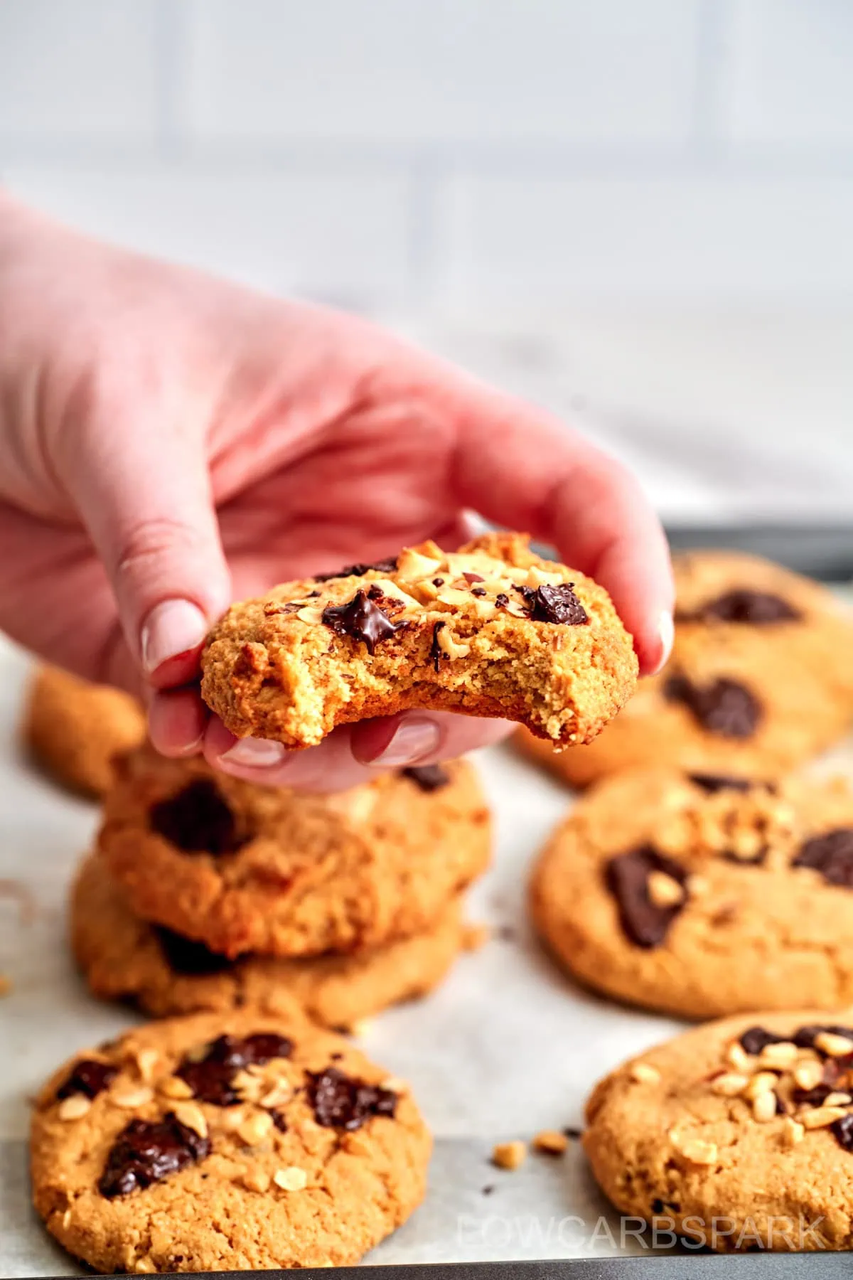 Keto Marry Me Cookies 3 A bite taken out of a keto cookie, highlighting the gooey chocolate inside.