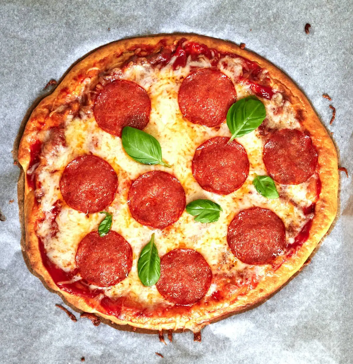 Cottage Cheese Pizza Crust 2 Whole cottage cheese crust pizza topped with pepperoni and fresh basil leaves.
