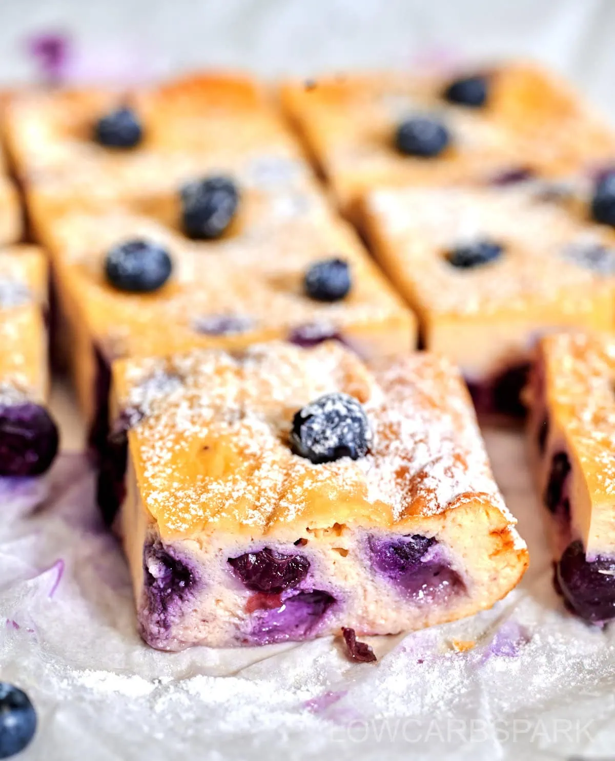 Greek Yogurt Bake 10 Highlighting the moist and creamy inside of a Greek yogurt bake loaded with berries.