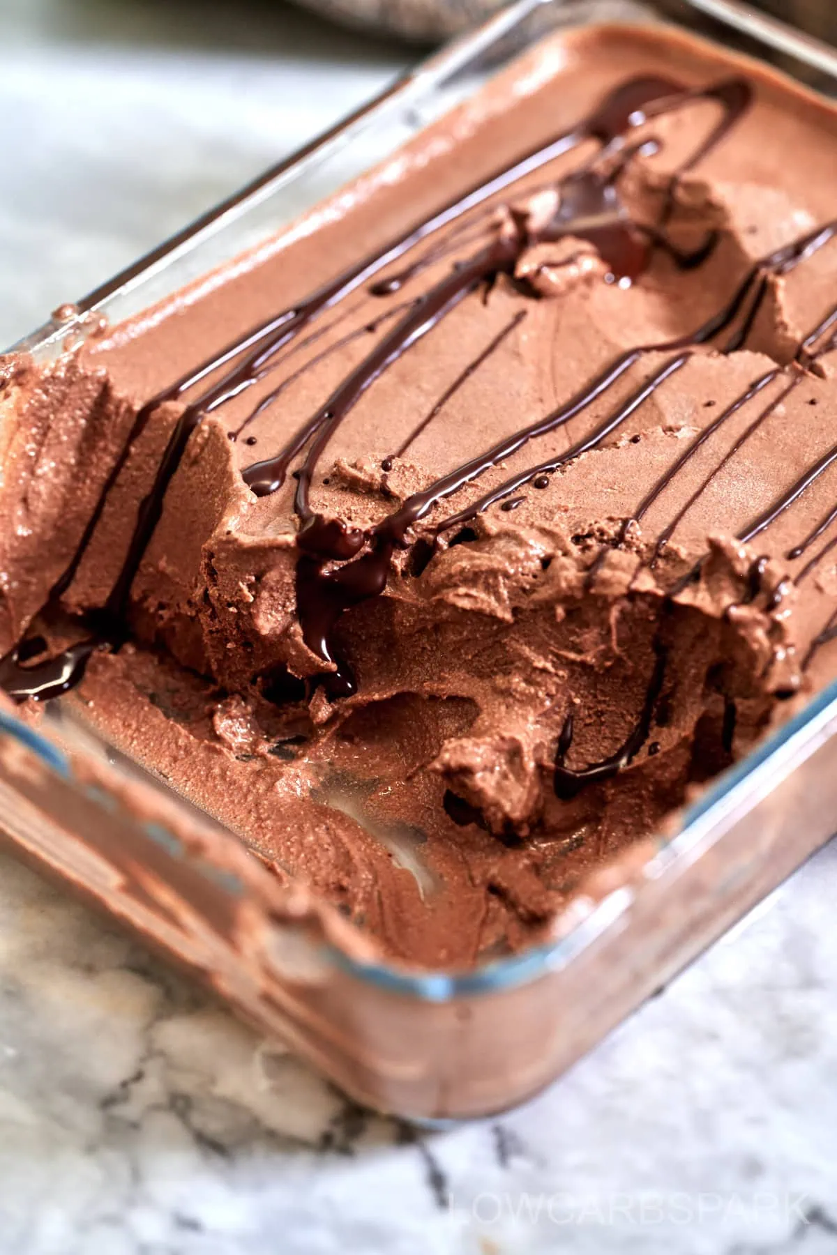 Chocolate Cottage Cheese Ice Cream 8 Homemade chocolate ice cream prepared and stored in a freezer-safe glass container.