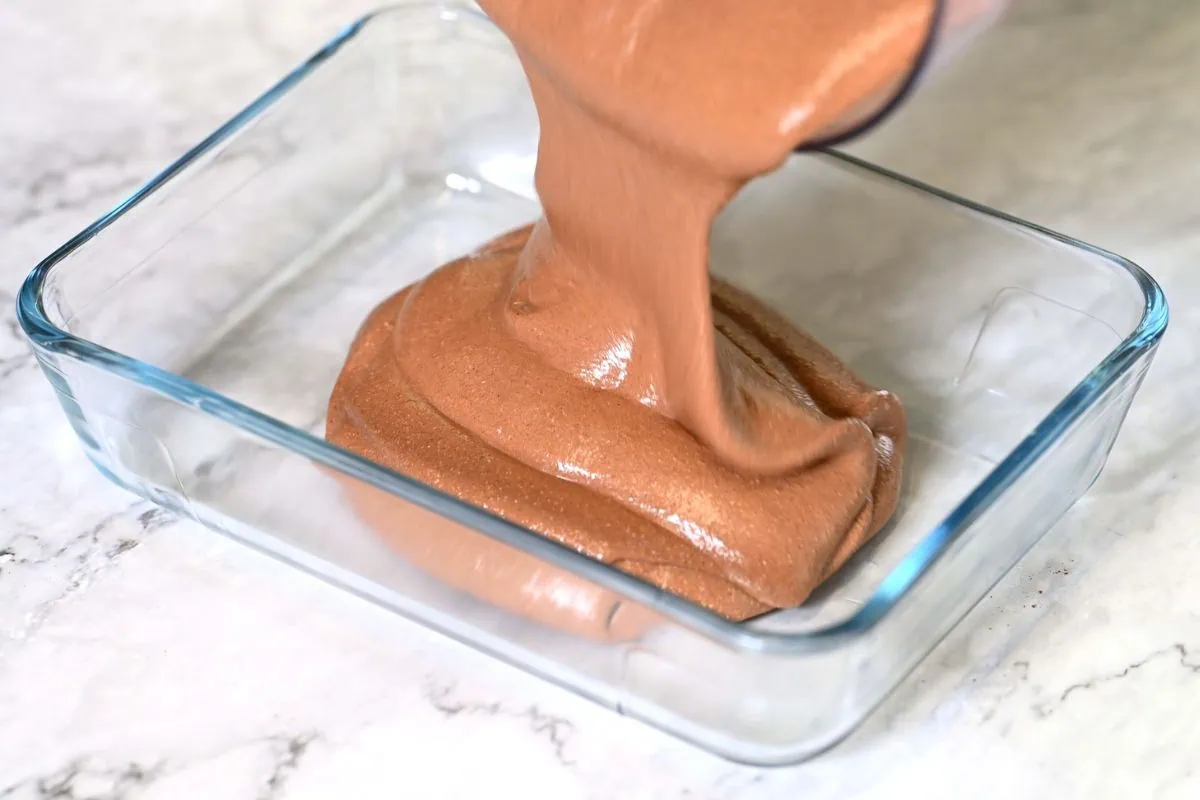 Chocolate Cottage Cheese Ice Cream 6 Pouring the chocolate cottage cheese mixture into a glass container.