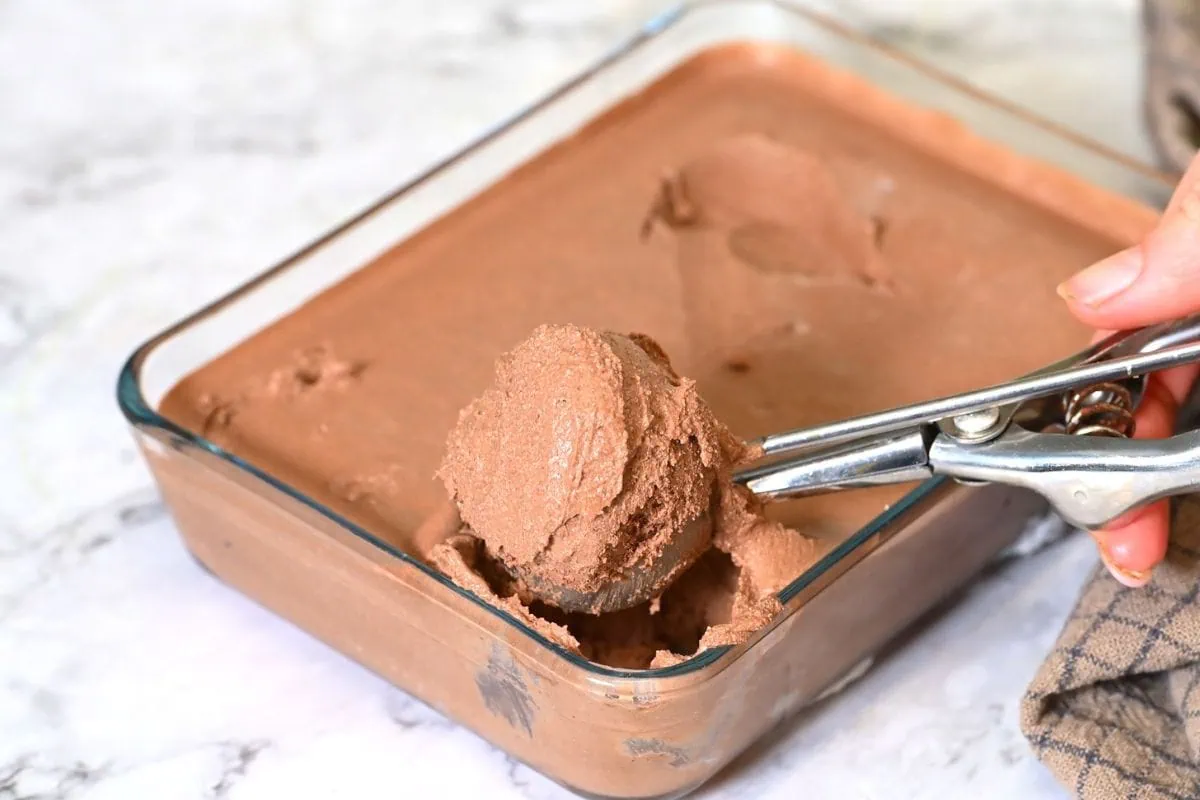 Chocolate Cottage Cheese Ice Cream 7 Finished no-churn chocolate ice cream being served from a glass dish.