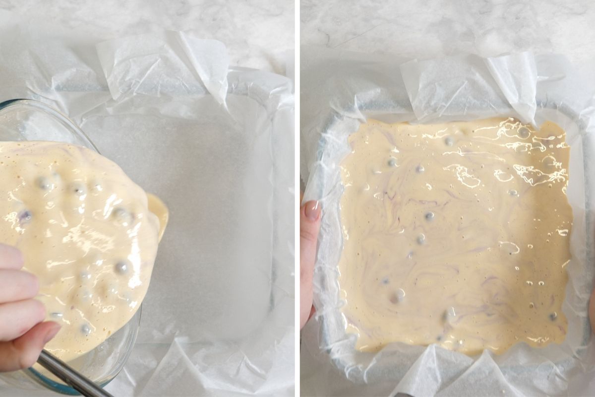 Pouring Greek yogurt blueberry batter into a parchment-lined baking dish.