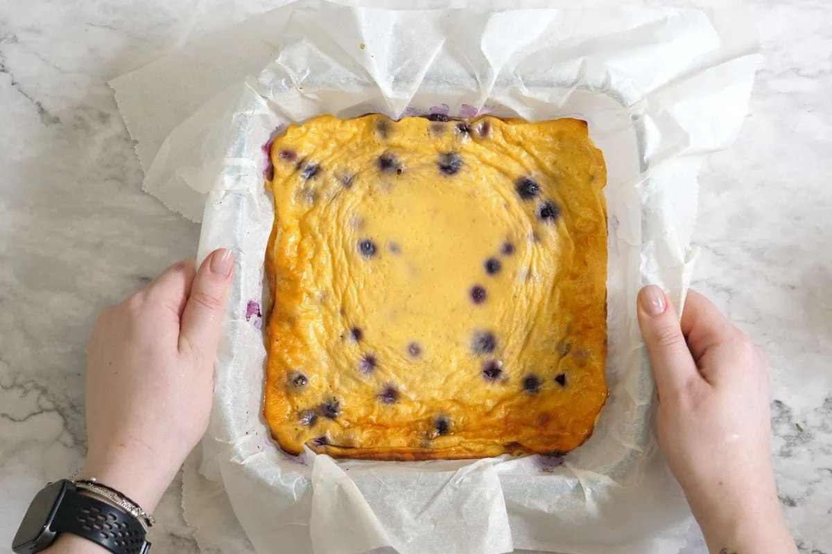 Greek Yogurt Bake 8 Freshly baked Greek yogurt dessert with blueberries in parchment paper.