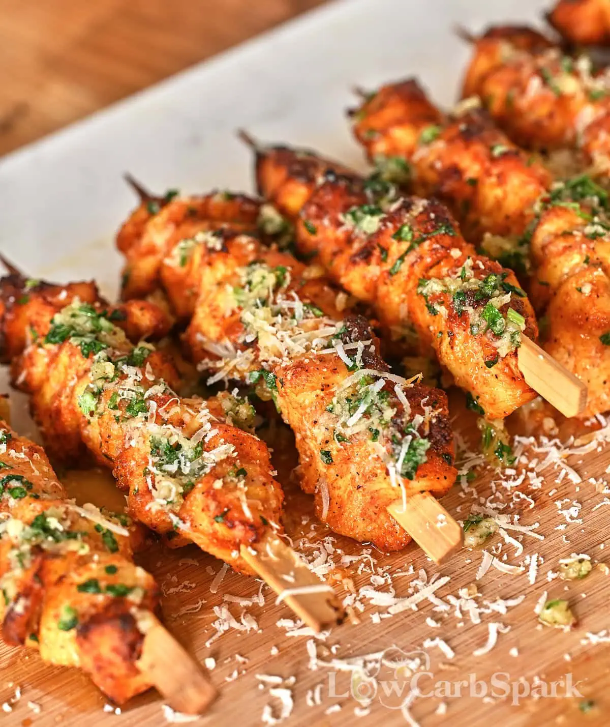 Ranch Garlic Parmesan Chicken Skewers 9 Golden brown ranch chicken skewers topped with chopped parsley and melted butter.
