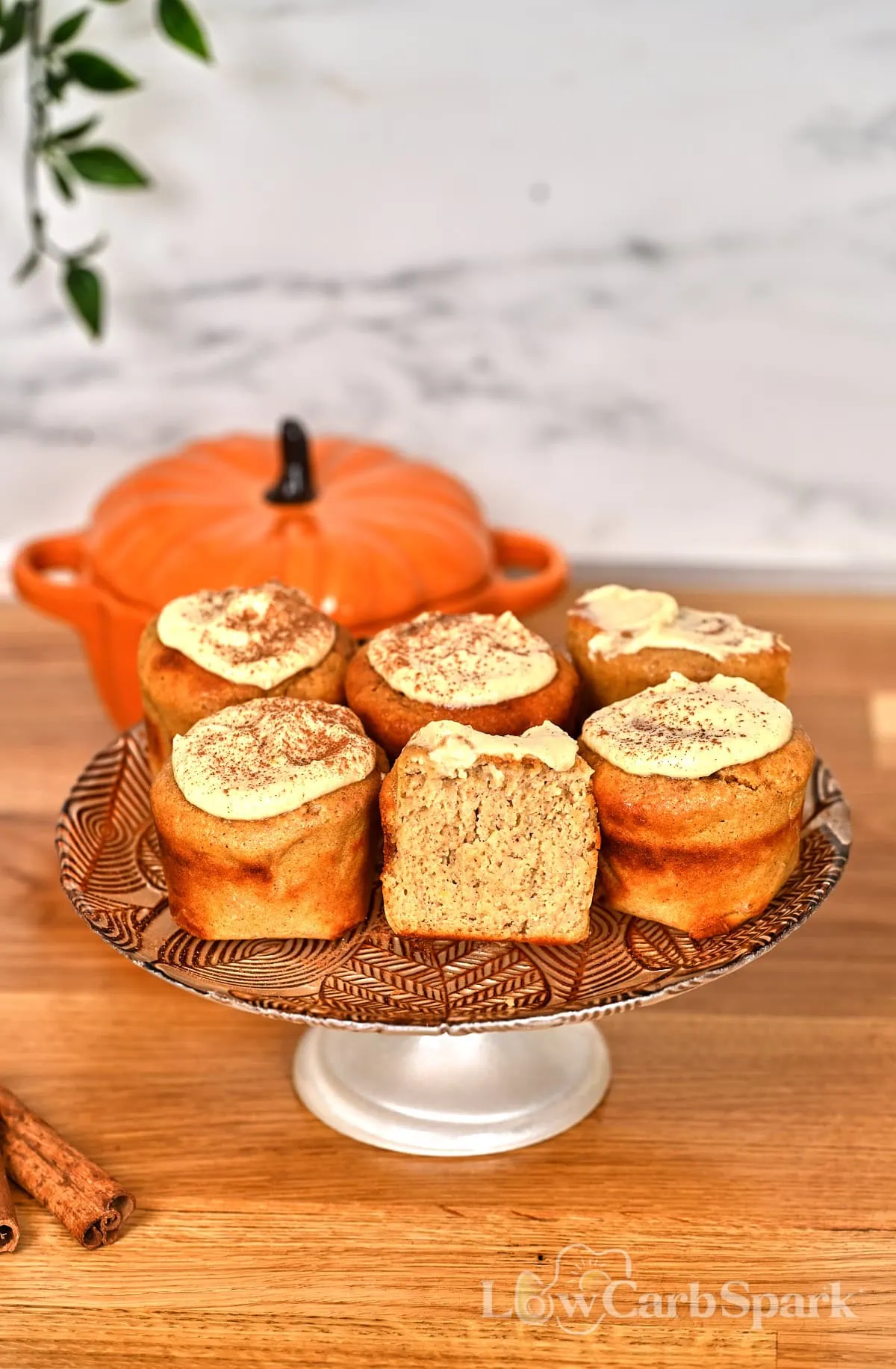 Cottage Cheese Pumpkin Muffins 3 Freshly baked cottage cheese pumpkin muffins arranged on a fall-themed dessert stand.