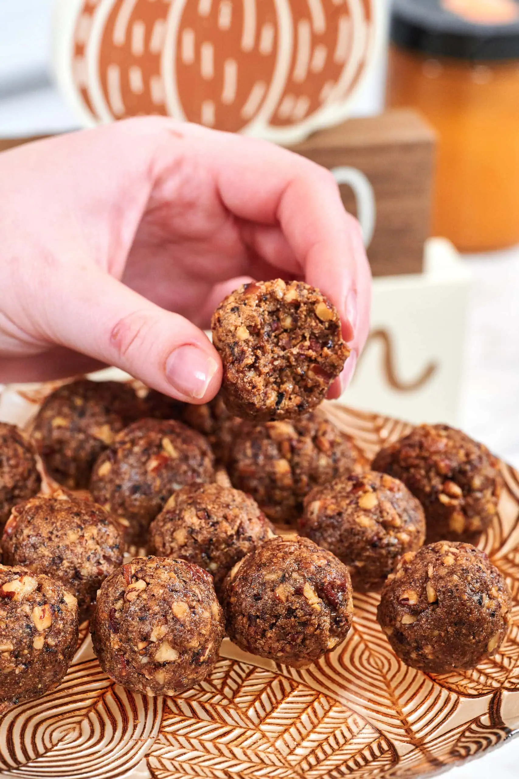 High-Protein Pecan Pie Balls 8 a close-up of a pecan pie ball cut in half showing the gooey center and pecan pieces