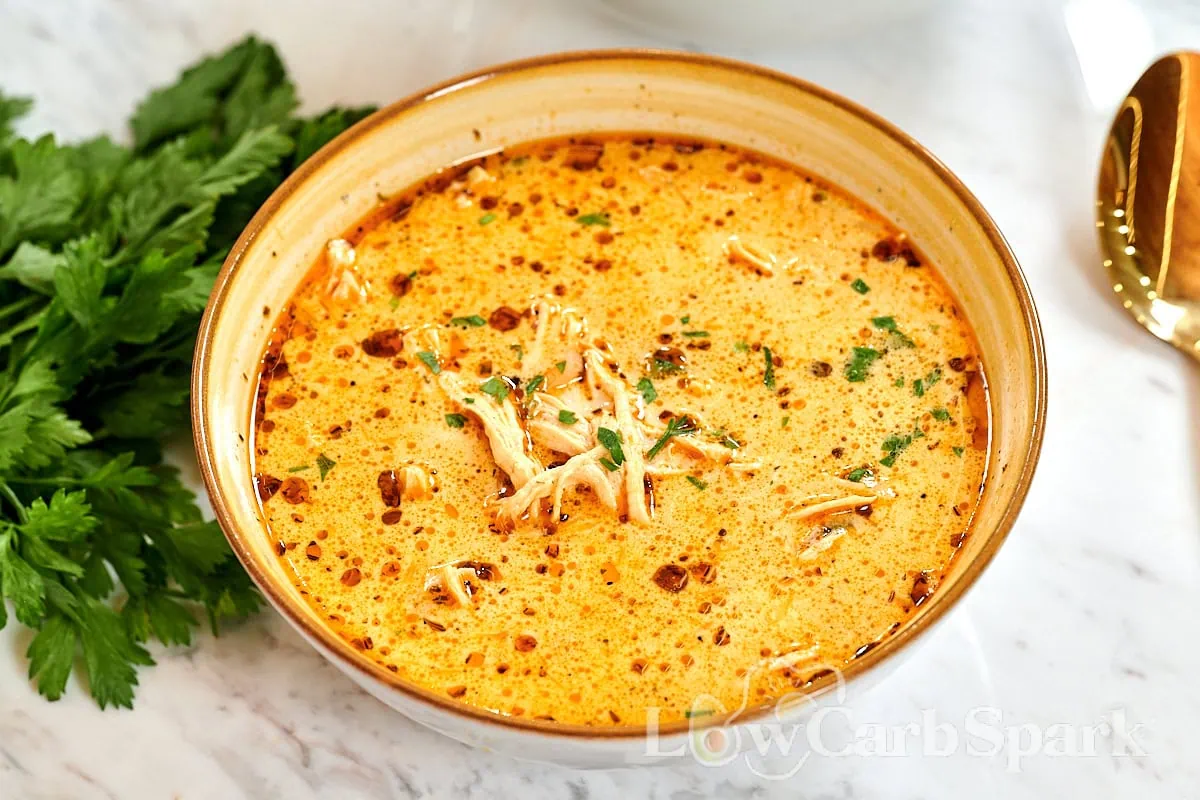 Creamy Turkey Soup 14 Bowl of creamy turkey soup garnished with parsley and chili oil drizzle.