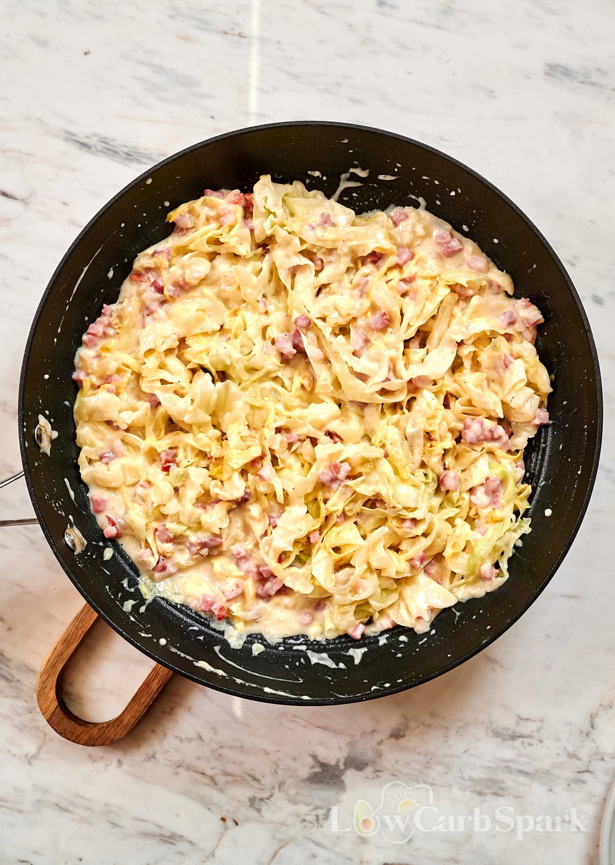 Cabbage Carbonara 10 Skillet filled with creamy cabbage carbonara made with sautéed cabbage, bacon, and parmesan sauce.