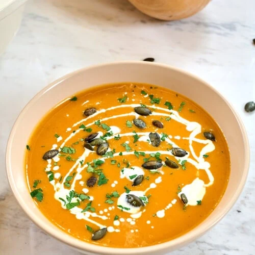 Creamy Roasted Butternut Squash Soup 5 Creamy butternut squash soup topped with pumpkin seeds, parsley, and a swirl of coconut milk