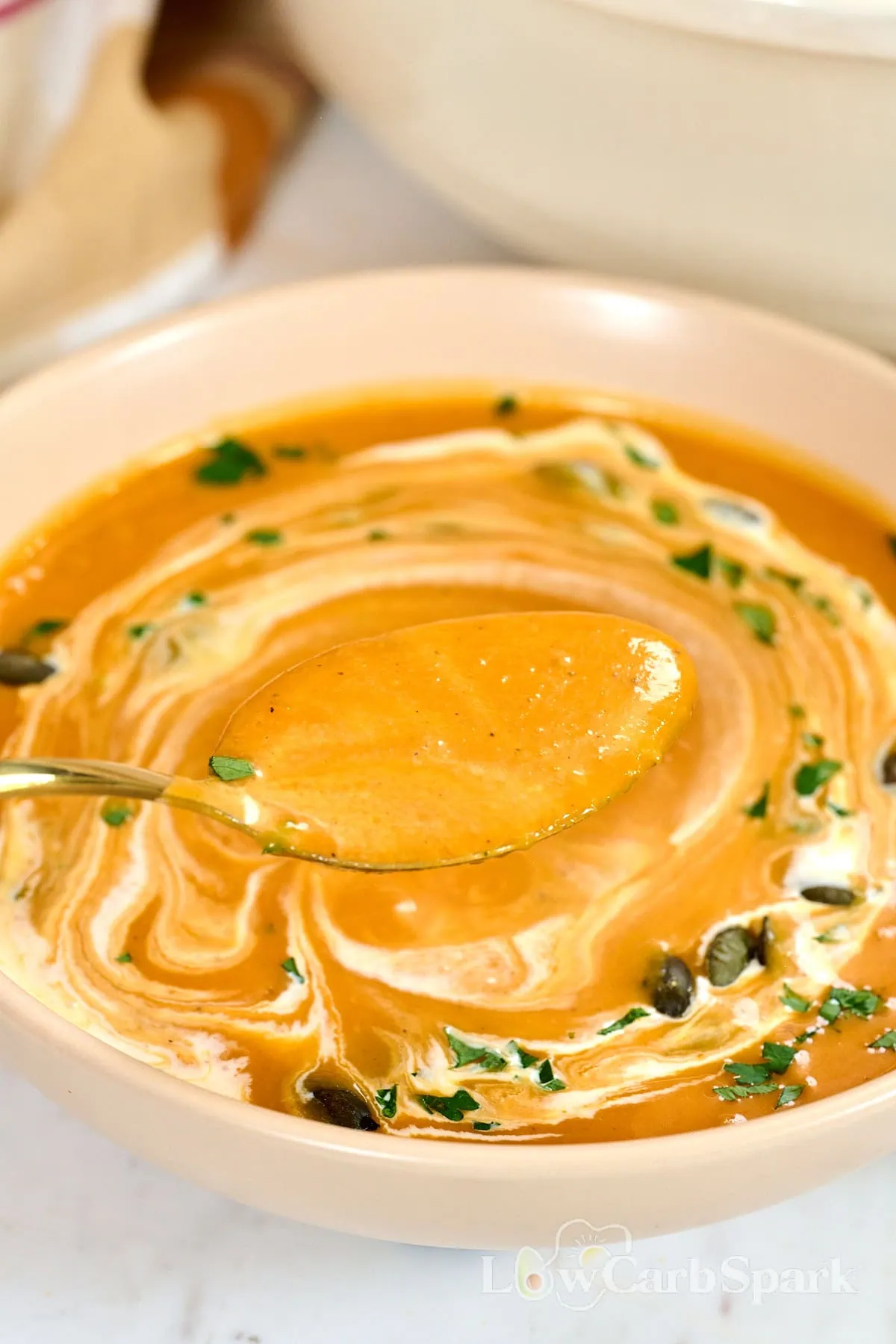 Creamy Roasted Butternut Squash Soup 3 Spoonful of smooth butternut squash soup topped with pumpkin seeds and fresh herbs
