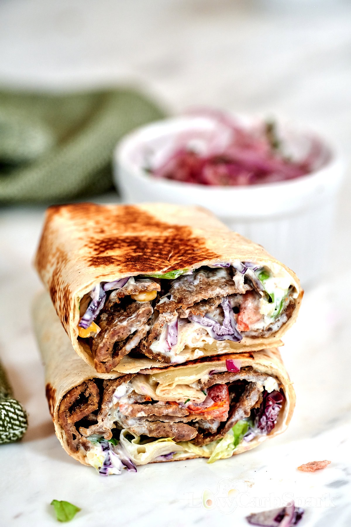 Grilled doner kebab wrap stuffed with juicy sliced meat, shredded cabbage, and creamy dressing.
