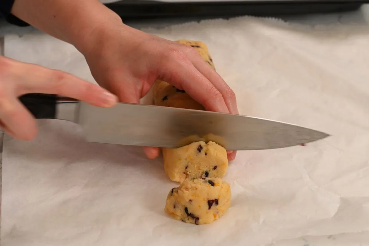 Almond Flour Cranberry Orange Cookies 8 Slicing almond flour cookie dough into rounds.