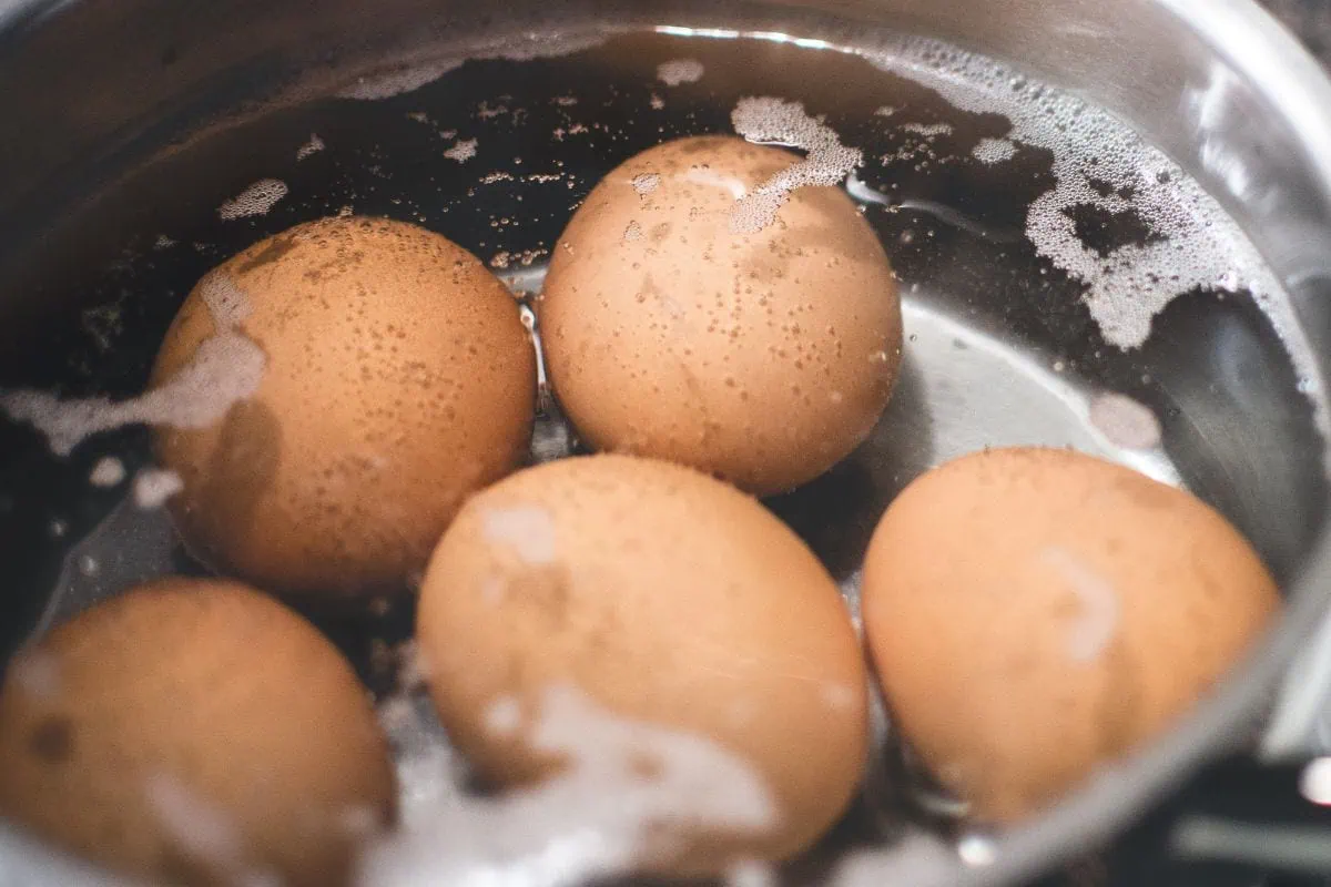 Boiled Egg Chocolate Mousse 3 Pot of brown eggs simmering in water to prepare for chocolate mousse recipe.