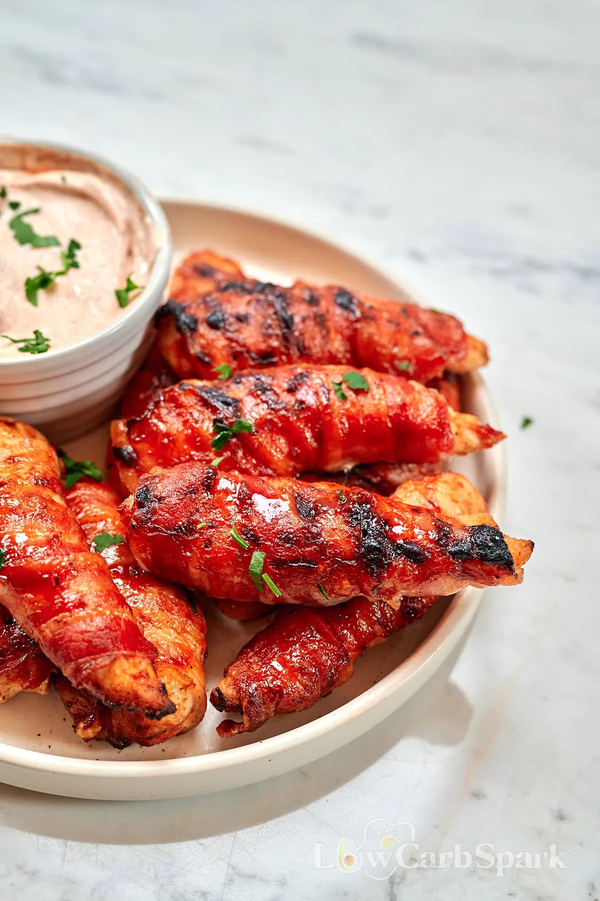 Barbecue Bacon-Wrapped Chicken Tenders 8 Barbecue bacon-wrapped chicken tenders served with creamy dipping sauce