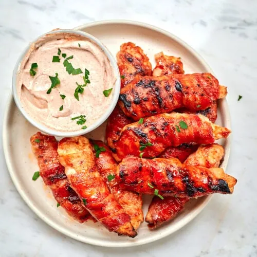Barbecue Bacon-Wrapped Chicken Tenders 11 Plate of barbecue bacon-wrapped chicken tenders with dipping sauce
