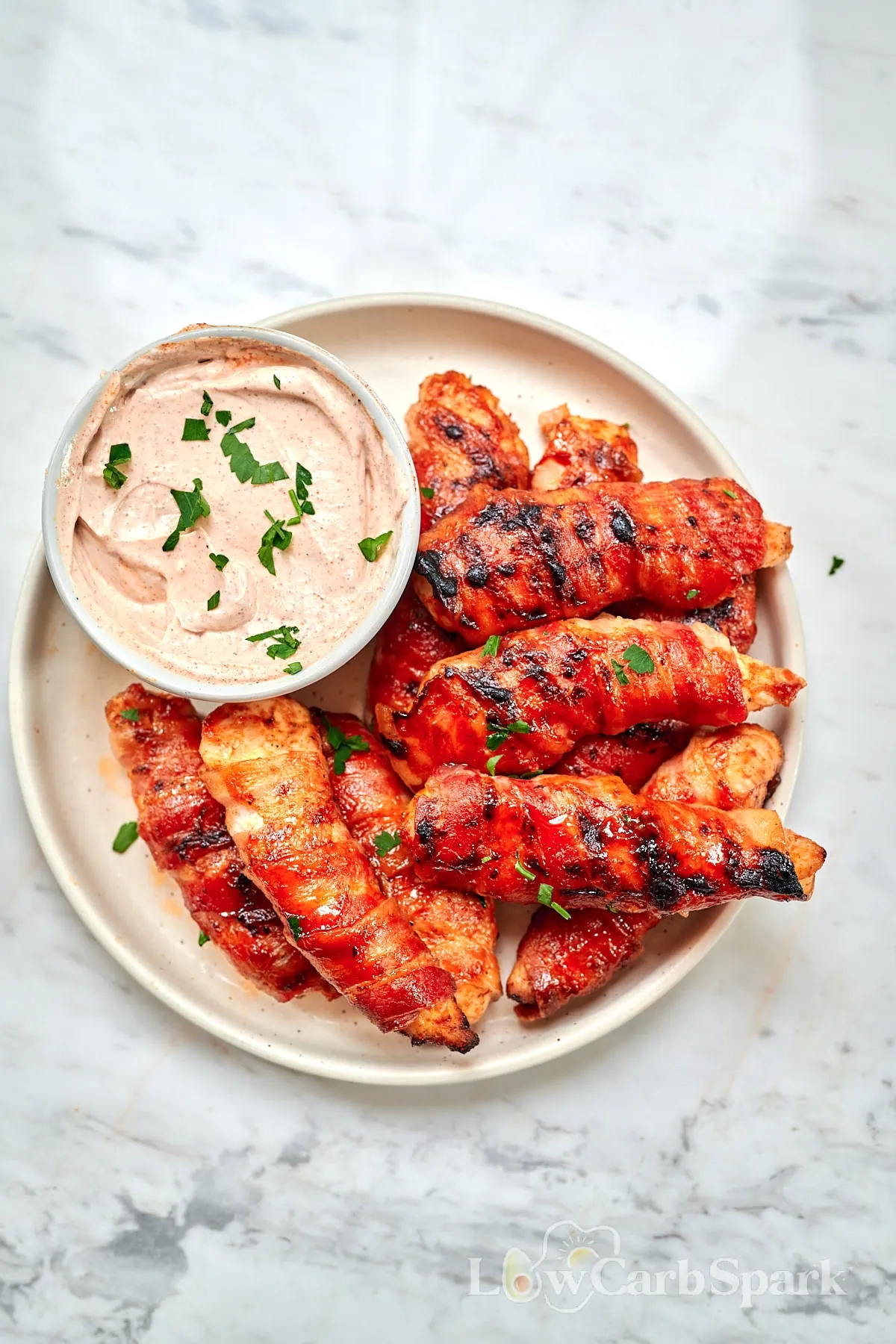 Barbecue Bacon-Wrapped Chicken Tenders 10 Plate of barbecue bacon-wrapped chicken tenders with dipping sauce