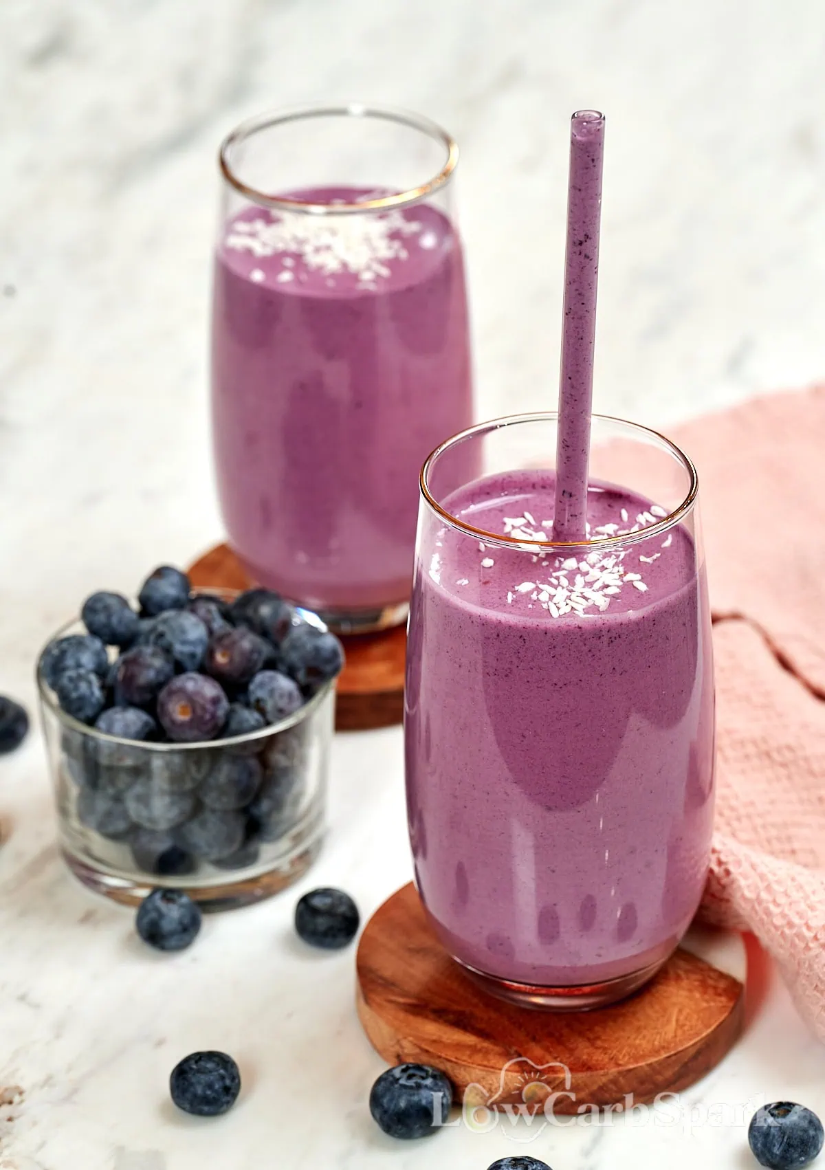 Cottage Cheese Blueberry Smoothie (High Protein!) 1 Cottage cheese blueberry smoothie in glasses topped with shredded coconut