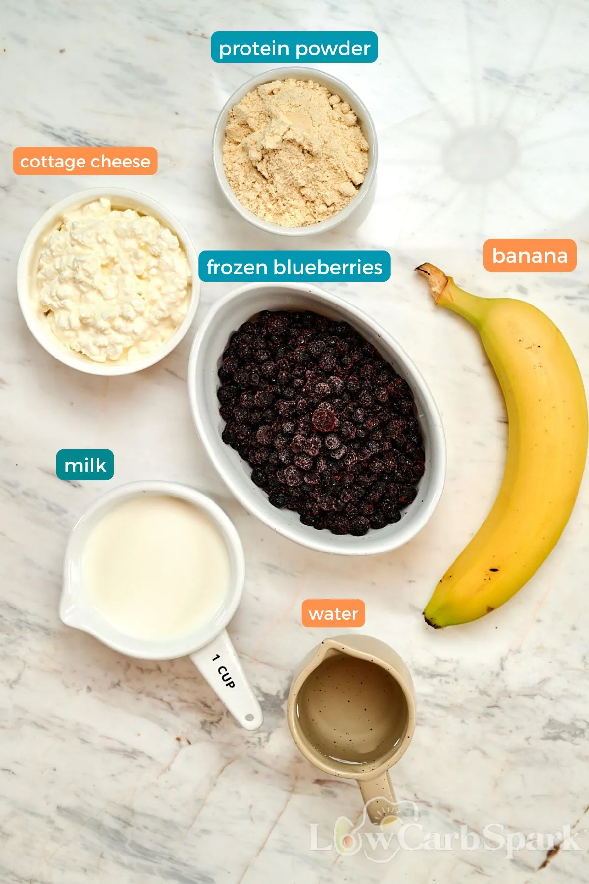 Cottage Cheese Blueberry Smoothie (High Protein!) 2 ngredients for cottage cheese blueberry smoothie on marble counter, including cottage cheese, blueberries and milk