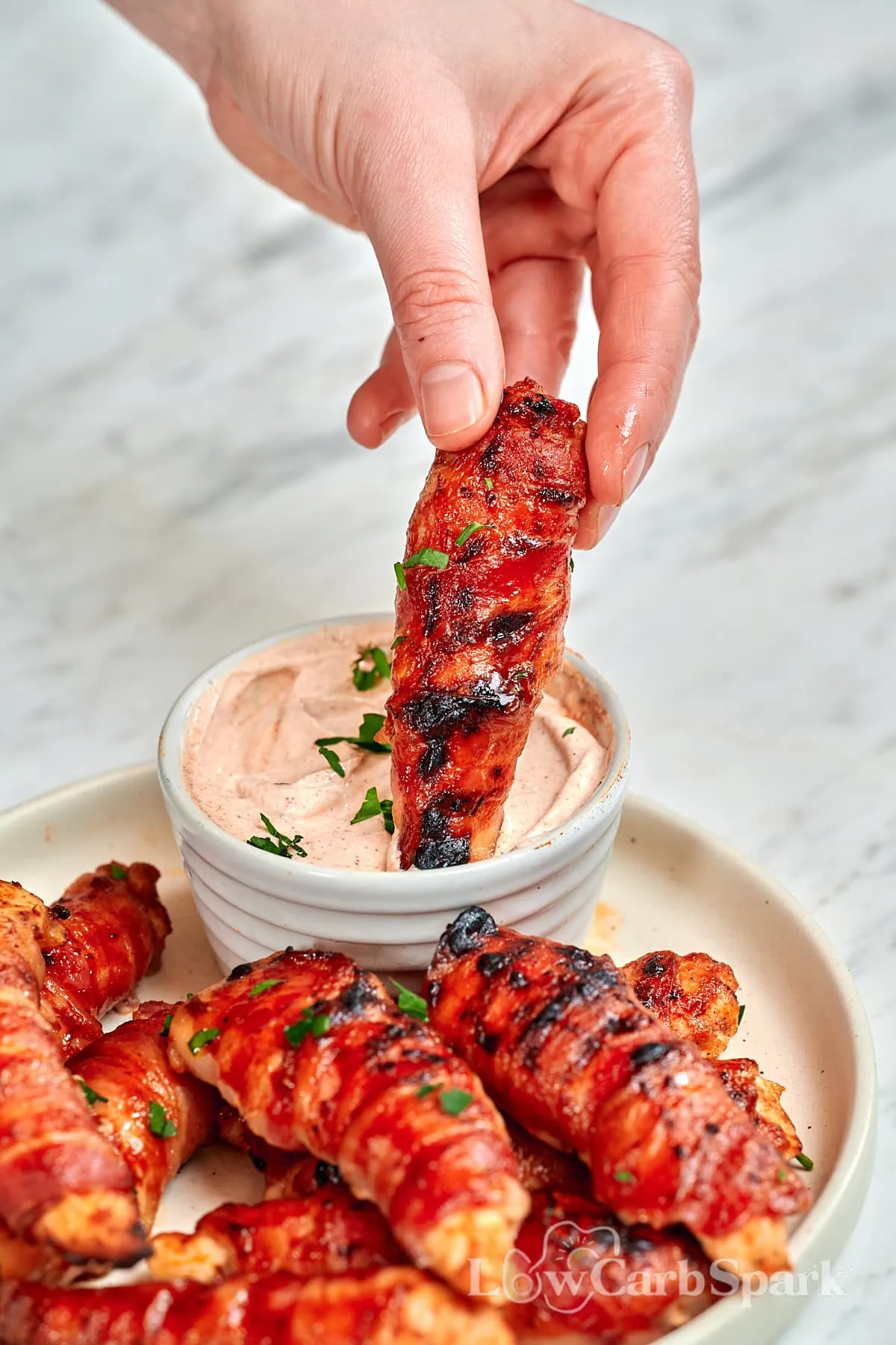 Barbecue Bacon-Wrapped Chicken Tenders 1 Bacon-wrapped chicken tender dipped into creamy barbecue sauce