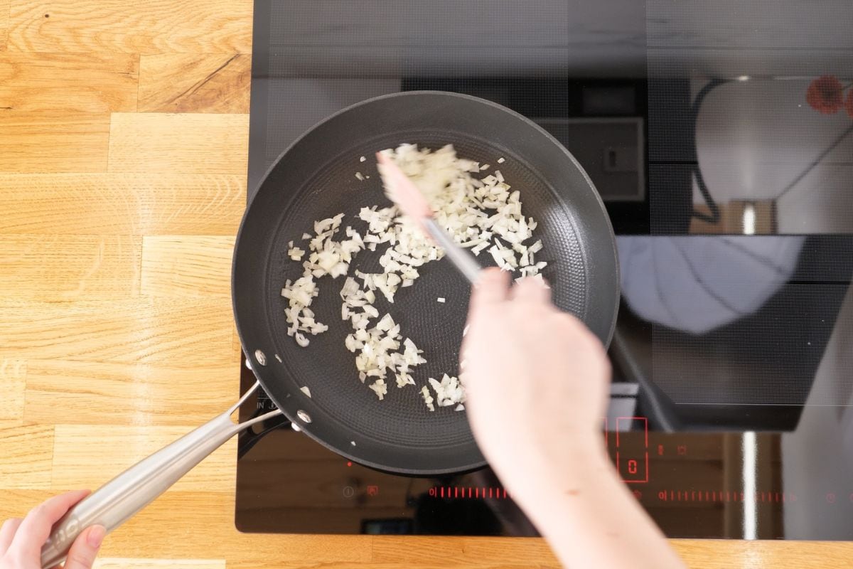 Cabbage Carbonara 5 Sautéing chopped onions in a skillet