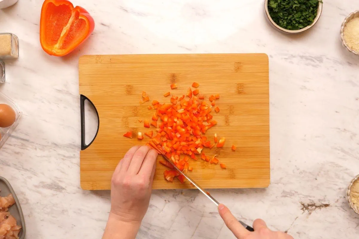 Cheesy Chicken Fritters 4 Chopping red bell pepper for cheesy chicken fritters