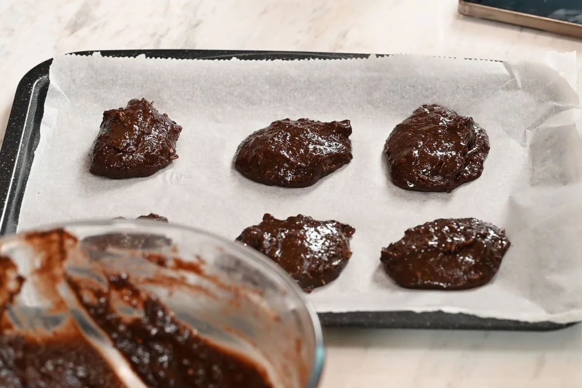 BEST High-Protein Chocolate Breakfast Cookies 6 Scooped chocolate cookie dough placed on a lined baking sheet