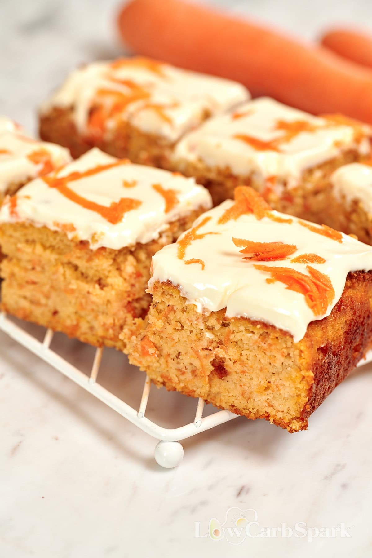Cottage Cheese Carrot Cake Bars 11 Close-up of moist cottage cheese carrot bars with thick creamy frosting on top.
