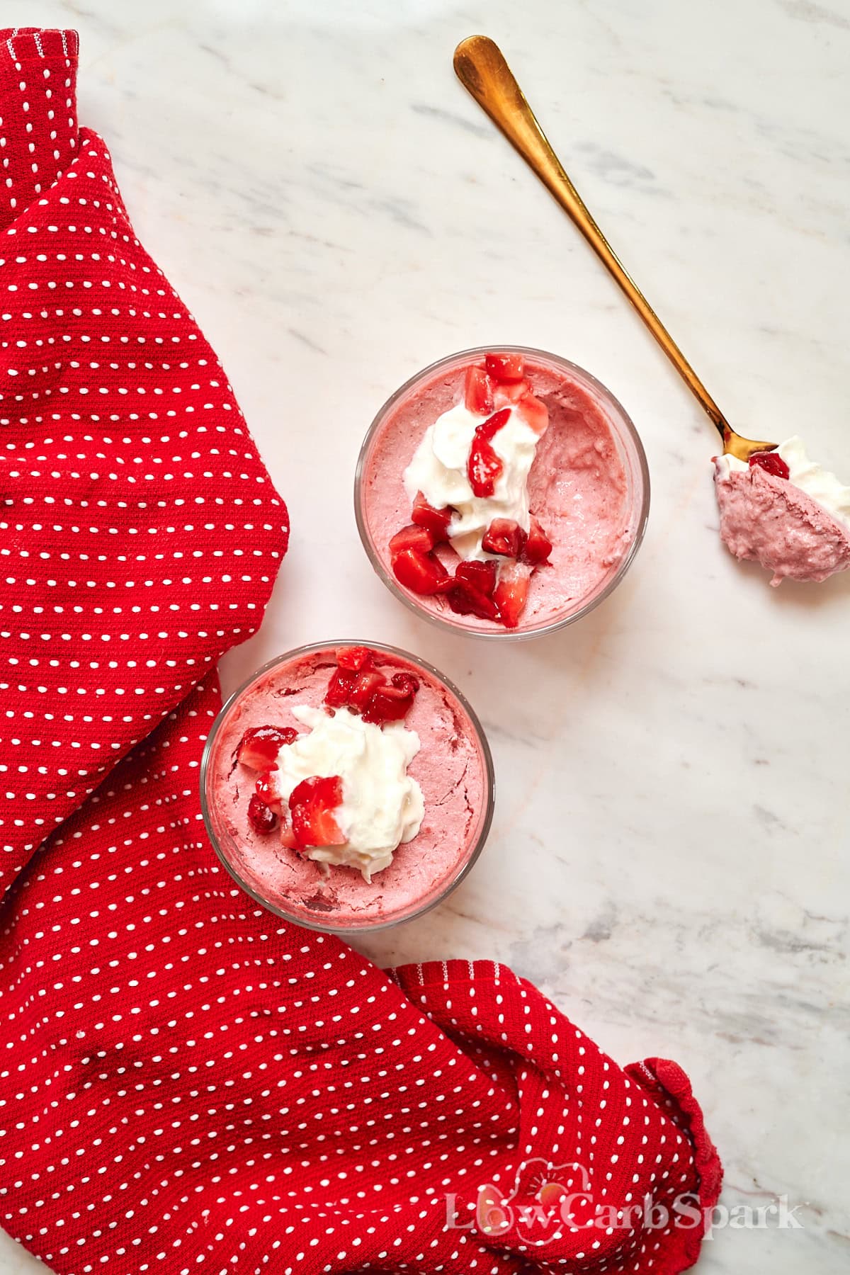 High-Protein Cottage Cheese Strawberry Mousse 2 Two glasses of strawberry cottage cheese mousse topped with whipped cream and fresh strawberries.