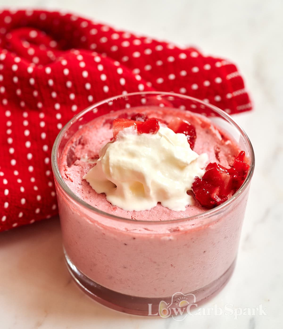 High-Protein Cottage Cheese Strawberry Mousse 9 Close-up of cottage cheese strawberry mousse with whipped cream and strawberry pieces.
