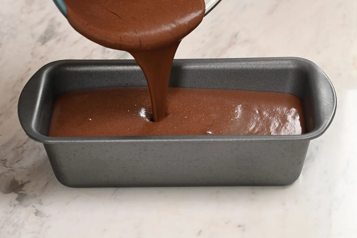 Chocolate Coconut Milk Ice Cream 5 Pouring creamy chocolate coconut milk ice cream base into a loaf pan before freezing.